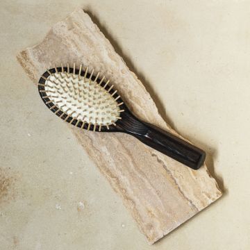 A front view of the ash hairbrush with  wooden pins.  