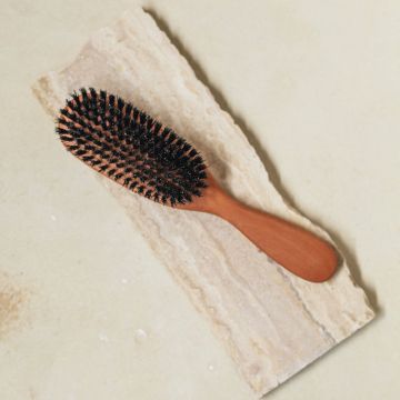 A front view of the boars hairbrush with wild boar bristles and pear wood.