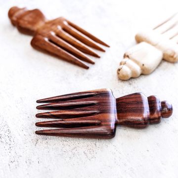 the nipa hair comb in teak, tamarind and rosewood close up aerial view on a table 